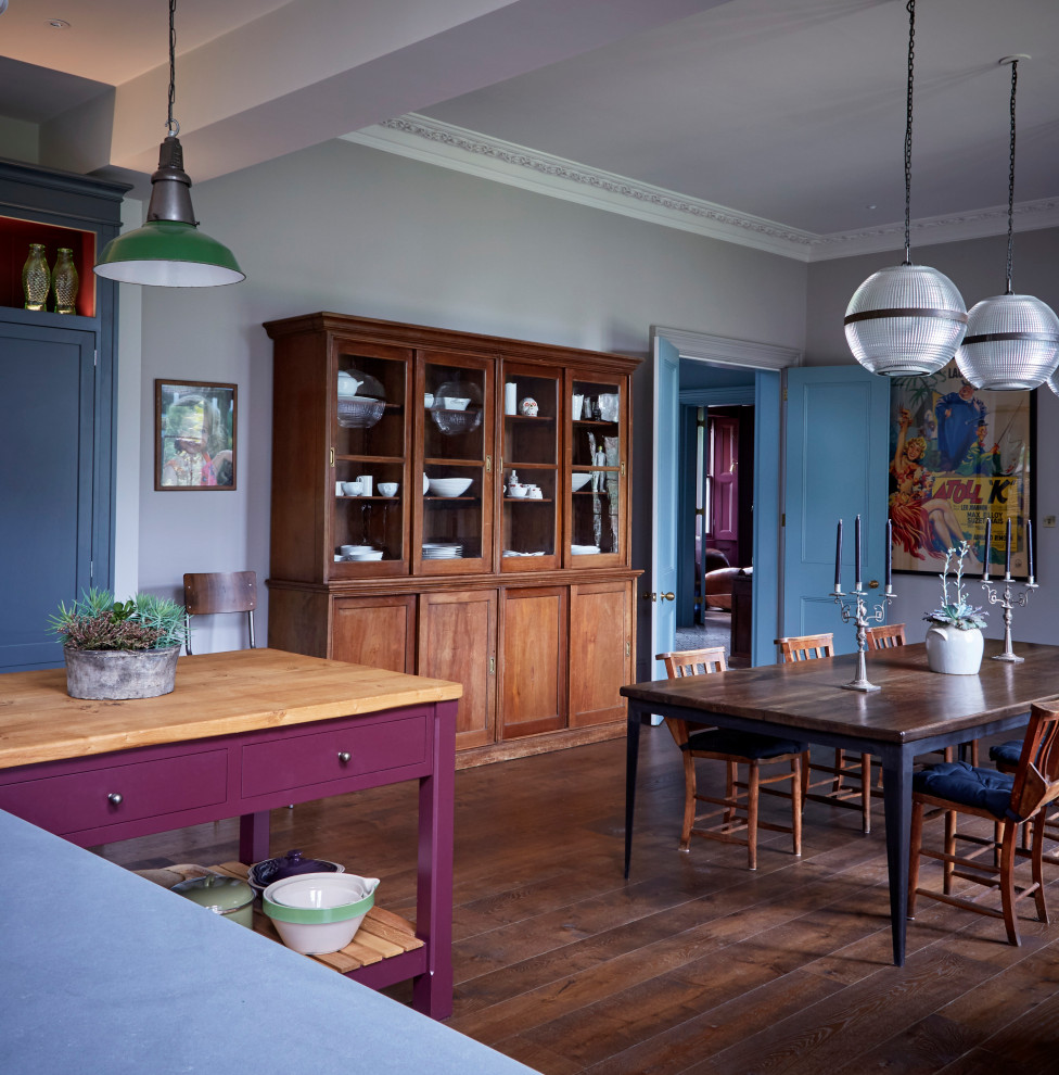 Photo of a large eclectic kitchen in London with dark hardwood floors, medium wood cabinets and multiple islands.