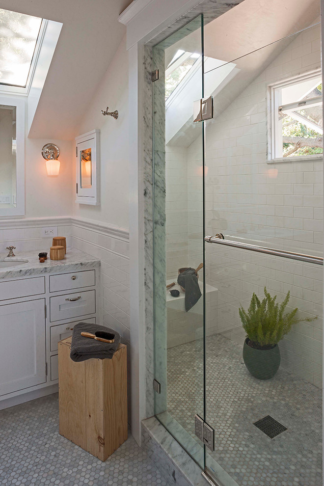 This is an example of a mid-sized arts and crafts master bathroom in San Francisco with shaker cabinets, white cabinets, an alcove shower, mosaic tile floors, an undermount sink, marble benchtops, a two-piece toilet, gray tile, subway tile and white walls.