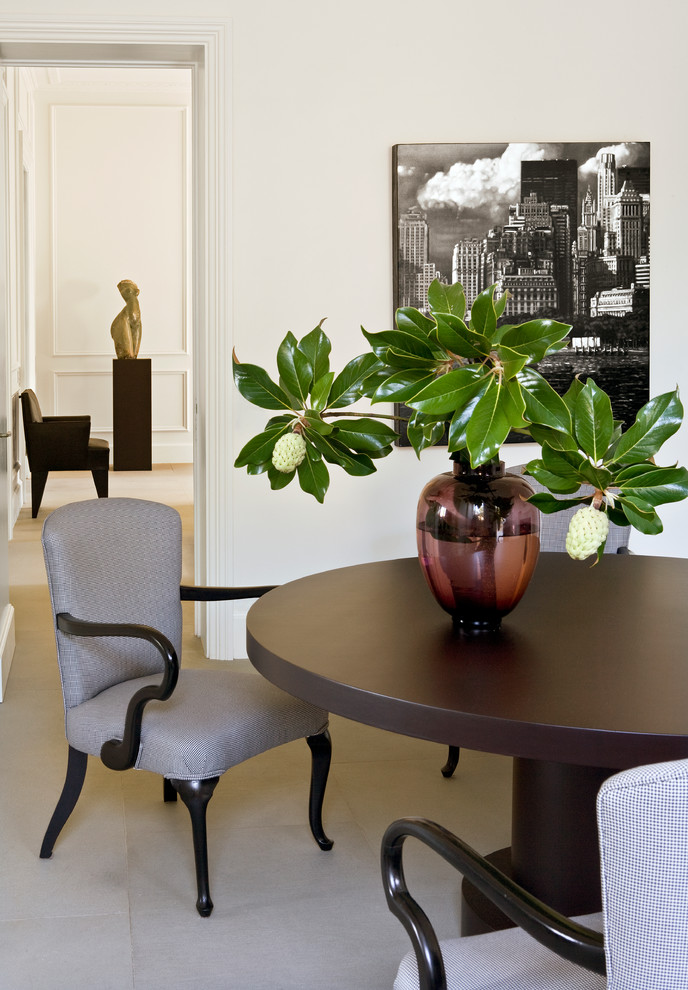 This is an example of a transitional dining room in Rome with white walls.