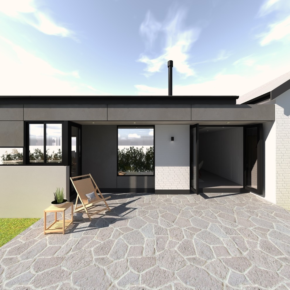 Mid-sized contemporary patio in Newcastle - Maitland with natural stone pavers and an awning.