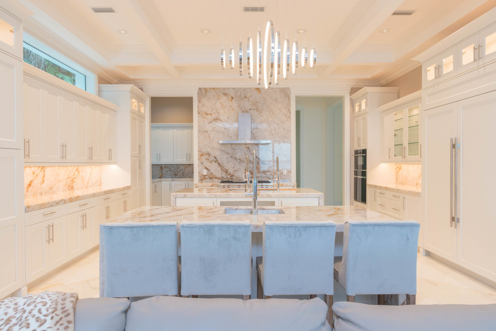 Inspiration for a huge transitional u-shaped marble floor and white floor open concept kitchen remodel with an undermount sink, flat-panel cabinets, white cabinets, quartzite countertops, white backsplash, stone slab backsplash and two islands