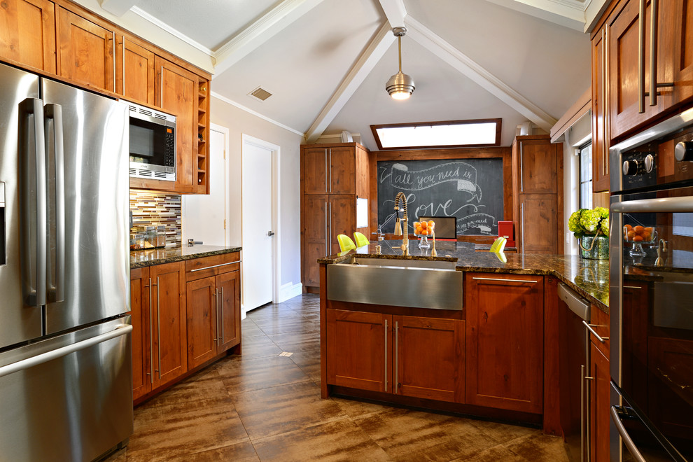 Example of a large transitional u-shaped travertine floor eat-in kitchen design in Dallas with a farmhouse sink, medium tone wood cabinets, granite countertops, multicolored backsplash, matchstick tile backsplash, stainless steel appliances and a peninsula