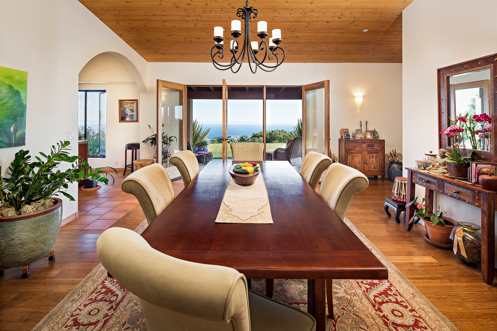 Expansive mediterranean dining room in Santa Barbara with white walls, medium hardwood floors and no fireplace.