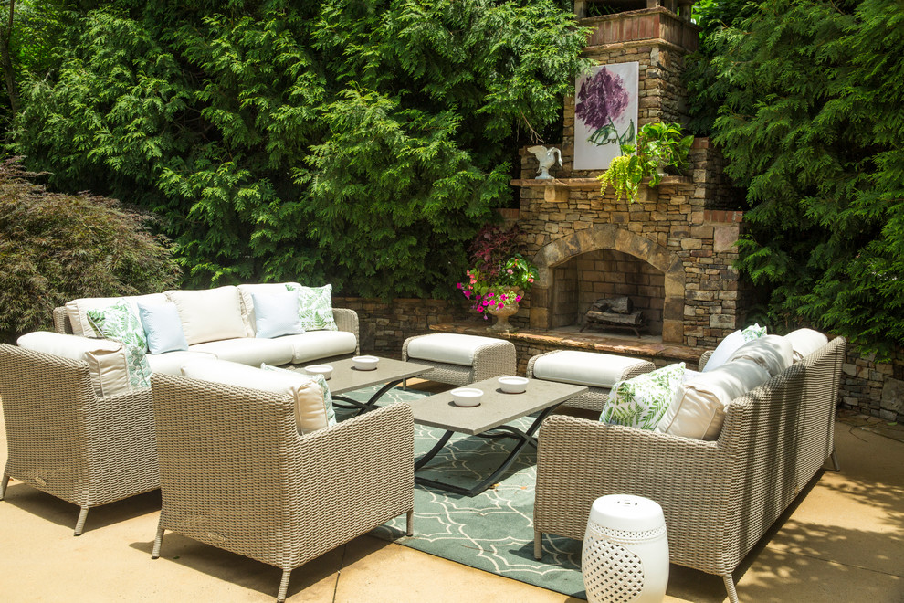 This is an example of a traditional patio in Atlanta with with fireplace and no cover.