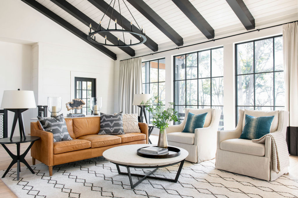 Design ideas for a large country open concept living room in Charleston with white walls, light hardwood floors, brown floor, vaulted and planked wall panelling.