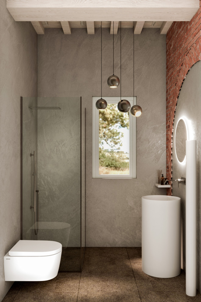 This is an example of a small eclectic powder room in Florence with white cabinets, a wall-mount toilet, grey walls, porcelain floors, a pedestal sink, brown floor, a freestanding vanity and wood.