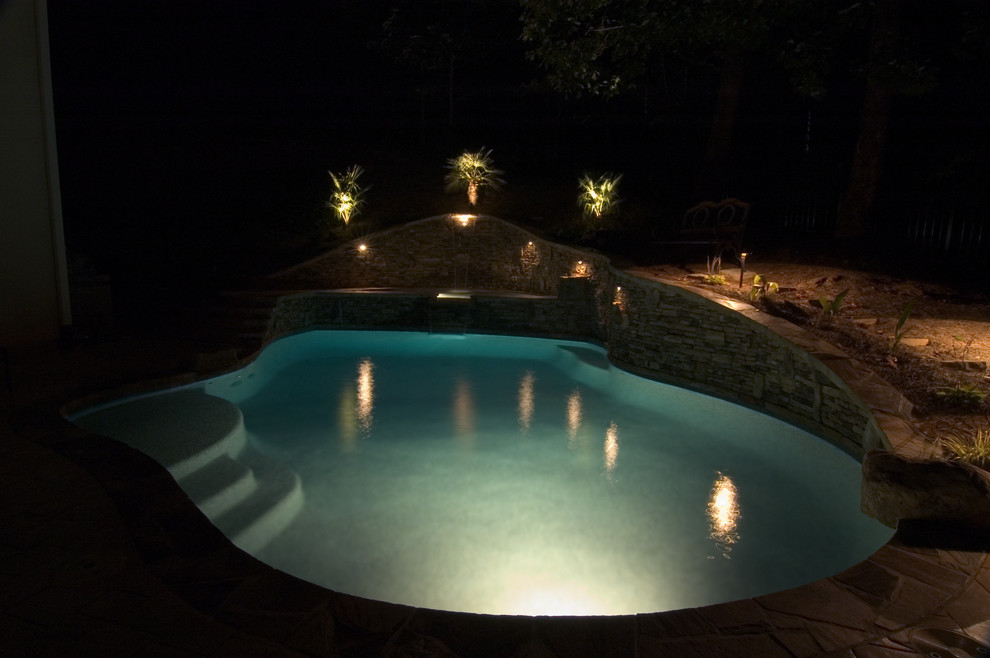 Mid-sized country backyard custom-shaped natural pool in Atlanta with a water feature and brick pavers.