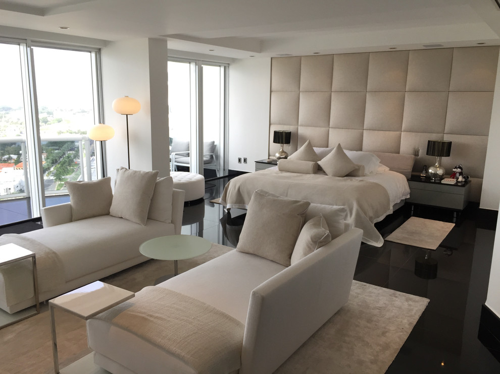 Design ideas for a large modern master bedroom in Miami with beige walls and marble floors.