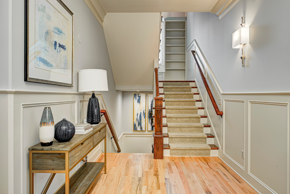 Mid-sized transitional wood u-shaped staircase in Indianapolis with wood risers and mixed railing.