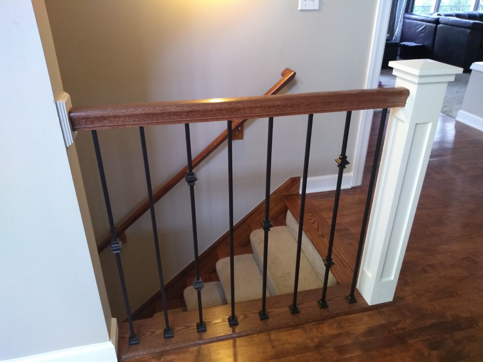White newels with oak rails and iron balusters