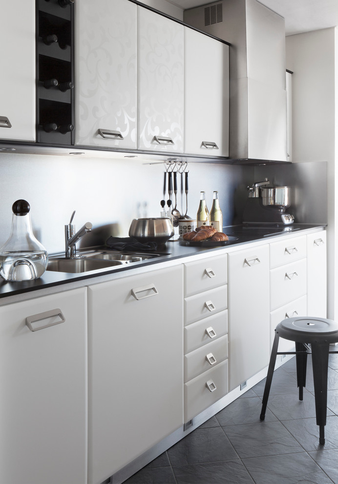 This is an example of a mid-sized scandinavian single-wall kitchen in Orebro with a double-bowl sink, flat-panel cabinets, white cabinets, ceramic floors and no island.