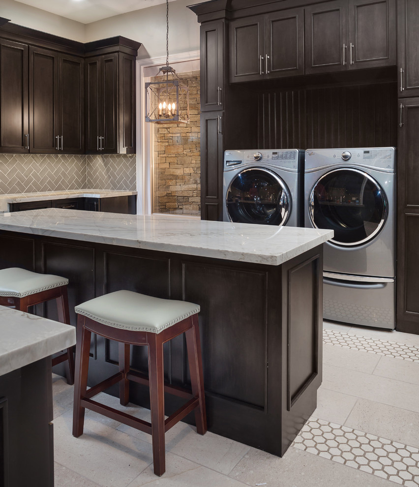 Design ideas for a large eclectic u-shaped dedicated laundry room in Phoenix with an undermount sink, shaker cabinets, marble benchtops, beige walls, porcelain floors, a side-by-side washer and dryer, black floor and dark wood cabinets.