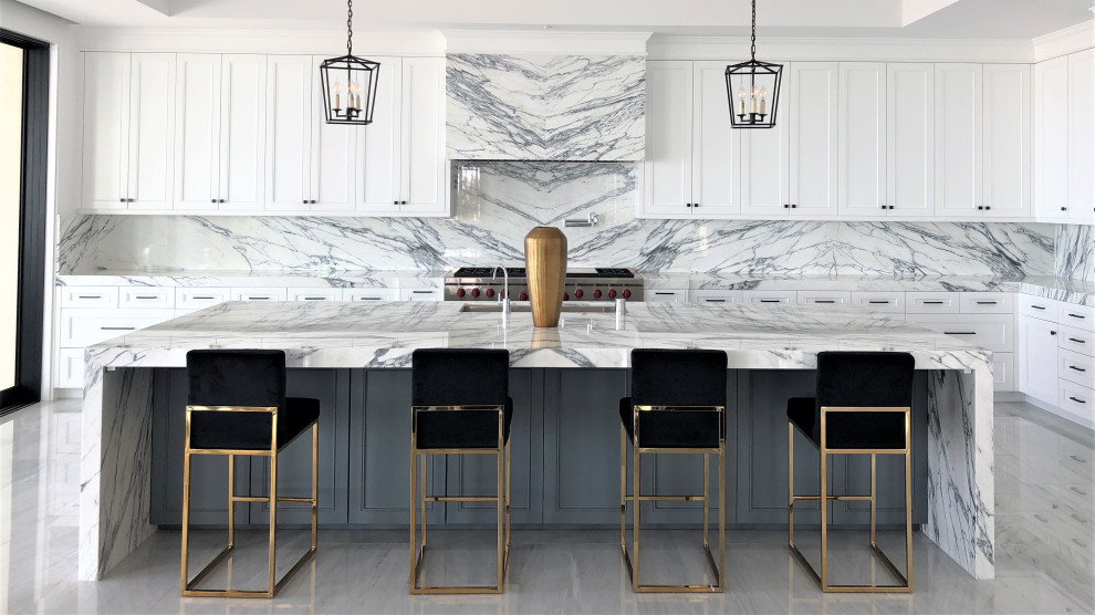 Design ideas for a contemporary l-shaped kitchen in Orange County with an undermount sink, shaker cabinets, white cabinets, grey splashback, stone slab splashback, with island, grey floor and grey benchtop.