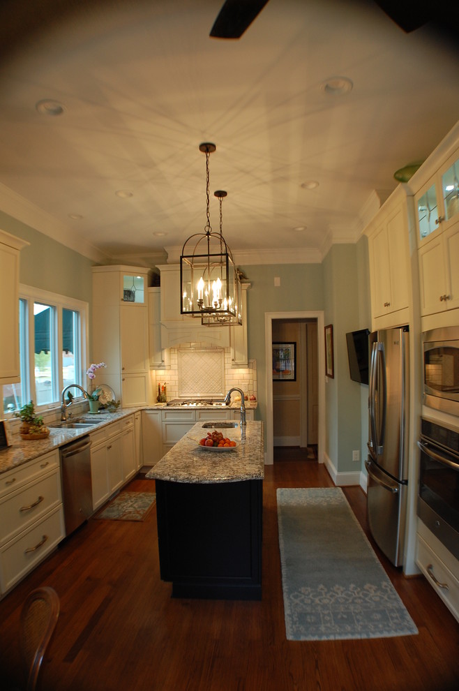 Transitional u-shaped eat-in kitchen photo in Raleigh with an undermount sink, recessed-panel cabinets, white cabinets, quartzite countertops, white backsplash, subway tile backsplash and stainless steel appliances