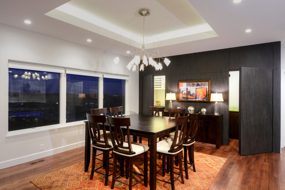 This is an example of a mid-sized contemporary kitchen/dining combo in Denver with grey walls and dark hardwood floors.