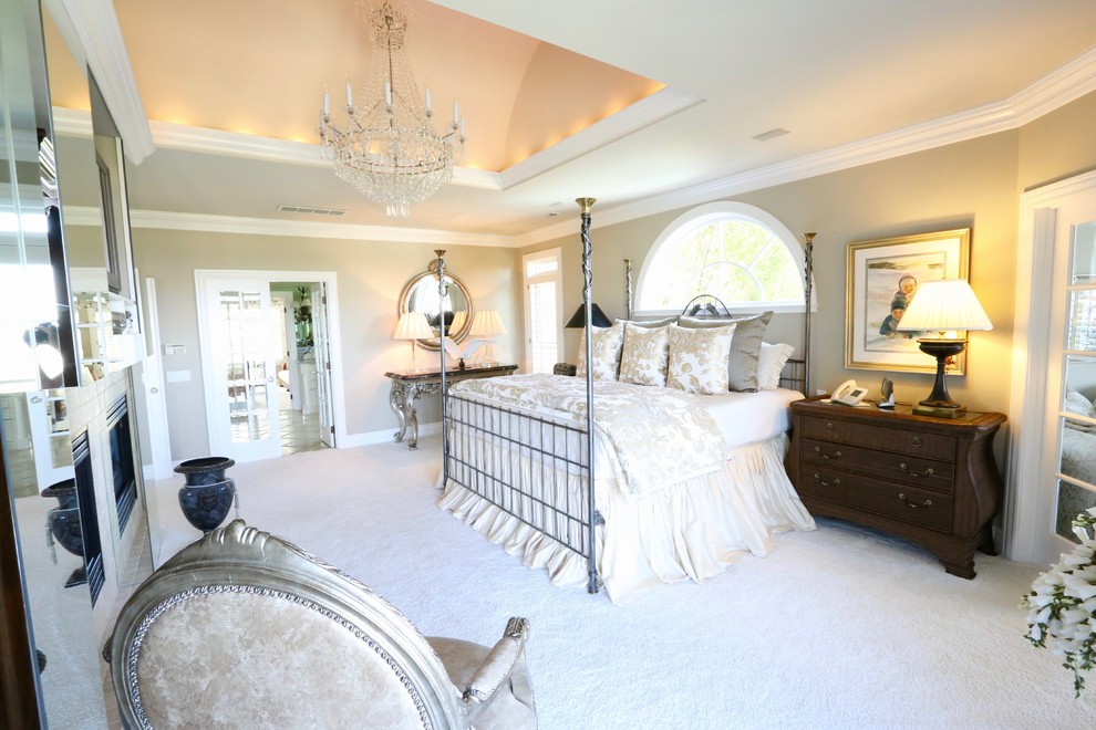 Photo of a large traditional master bedroom in Seattle with beige walls, carpet, no fireplace and white floor.