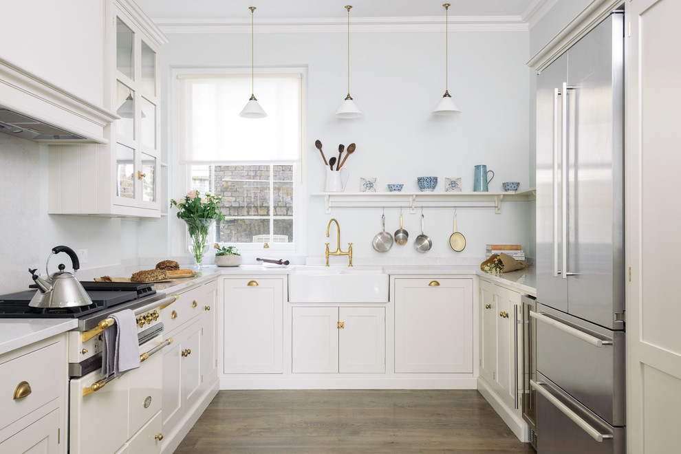 Design ideas for a mid-sized country u-shaped separate kitchen in Other with a farmhouse sink, shaker cabinets, beige cabinets, white splashback, coloured appliances, dark hardwood floors and no island.