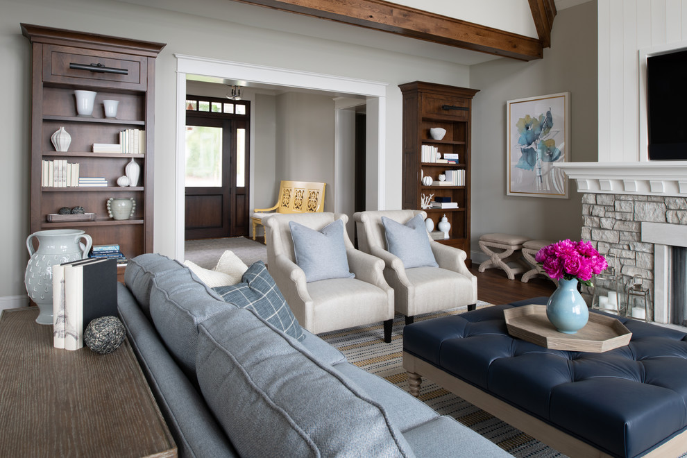 Design ideas for a mid-sized beach style enclosed family room in Minneapolis with a music area, beige walls, medium hardwood floors, a standard fireplace, a stone fireplace surround, a wall-mounted tv and brown floor.