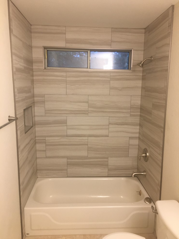 Photo of a mid-sized transitional kids bathroom in Austin with recessed-panel cabinets, an alcove tub, a two-piece toilet, gray tile, porcelain tile, beige walls, ceramic floors, an undermount sink, beige floor, a shower/bathtub combo and a shower curtain.