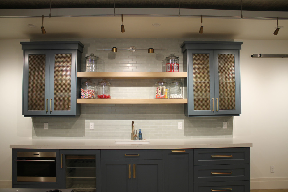 Photo of a mid-sized transitional galley wet bar in Salt Lake City with an undermount sink, shaker cabinets, blue cabinets, quartz benchtops and beige benchtop.