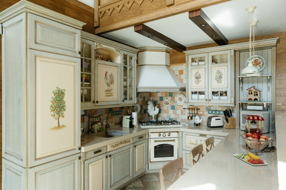 Large country u-shaped eat-in kitchen in Moscow with raised-panel cabinets, green cabinets, solid surface benchtops, mosaic tile splashback, ceramic floors, a peninsula, beige benchtop and exposed beam.