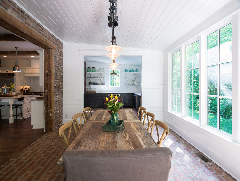 Traditional dining room in Nashville with brick floors and white walls.