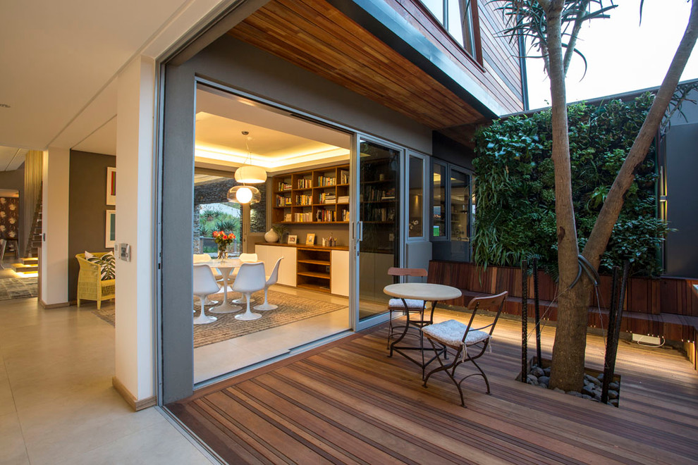 This is an example of a contemporary courtyard deck in Other with a vertical garden.