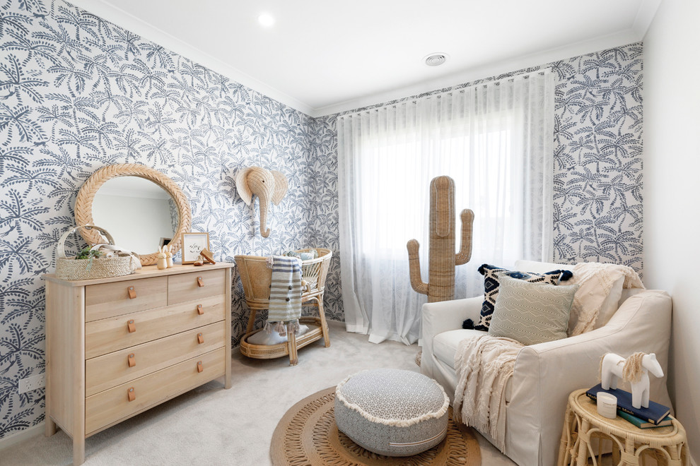 Photo of a beach style nursery in Melbourne with blue walls, carpet and grey floor.