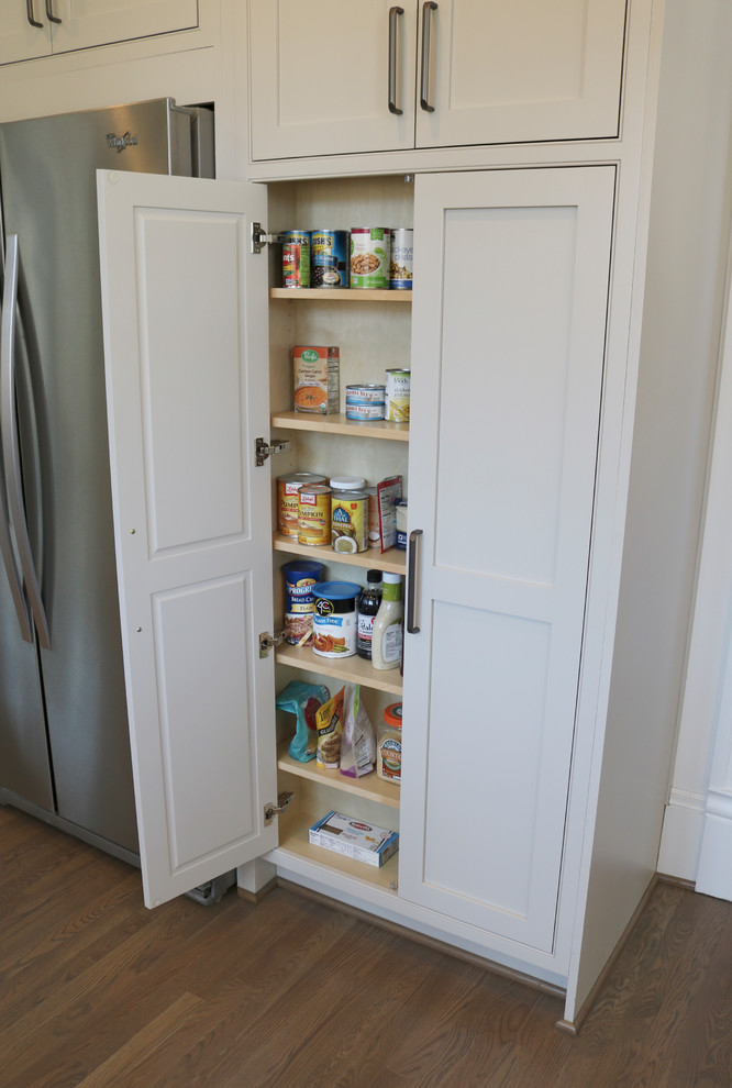 Enclosed kitchen - large transitional galley medium tone wood floor and brown floor enclosed kitchen idea with a farmhouse sink, shaker cabinets, gray cabinets, quartzite countertops, stainless steel appliances, beige backsplash, subway tile backsplash and a peninsula
