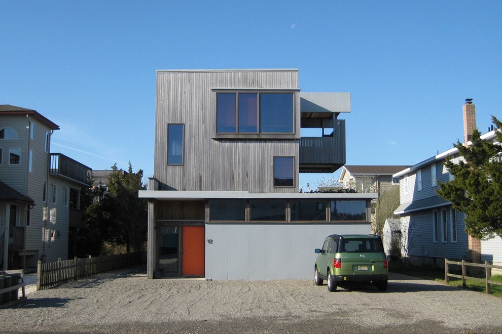 Design ideas for a contemporary two-storey exterior in Newark with wood siding.