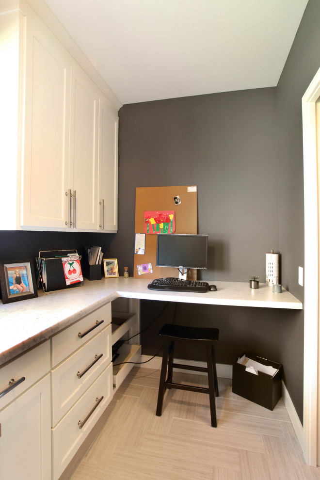 This is an example of a mid-sized traditional u-shaped utility room in Minneapolis with flat-panel cabinets, white cabinets, laminate benchtops, grey walls, laminate floors, a side-by-side washer and dryer, grey floor and white benchtop.