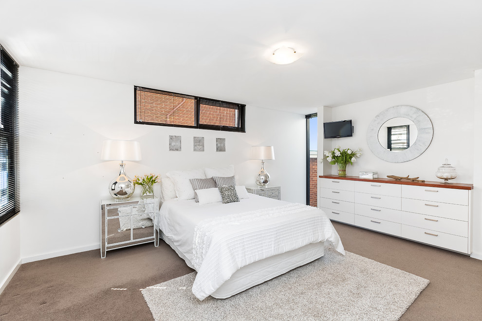 Design ideas for a large contemporary guest bedroom in Sydney with white walls, carpet and brown floor.