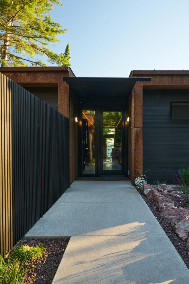 Example of a mountain style entryway design in Seattle with a glass front door