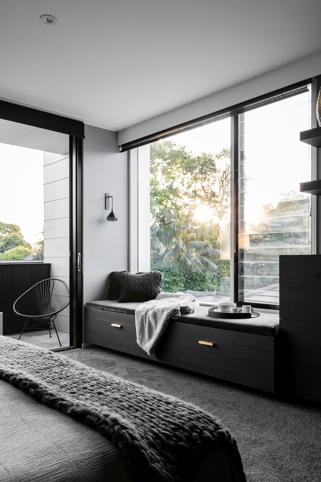 Inspiration for a large contemporary master bedroom in Sydney with grey walls and carpet.