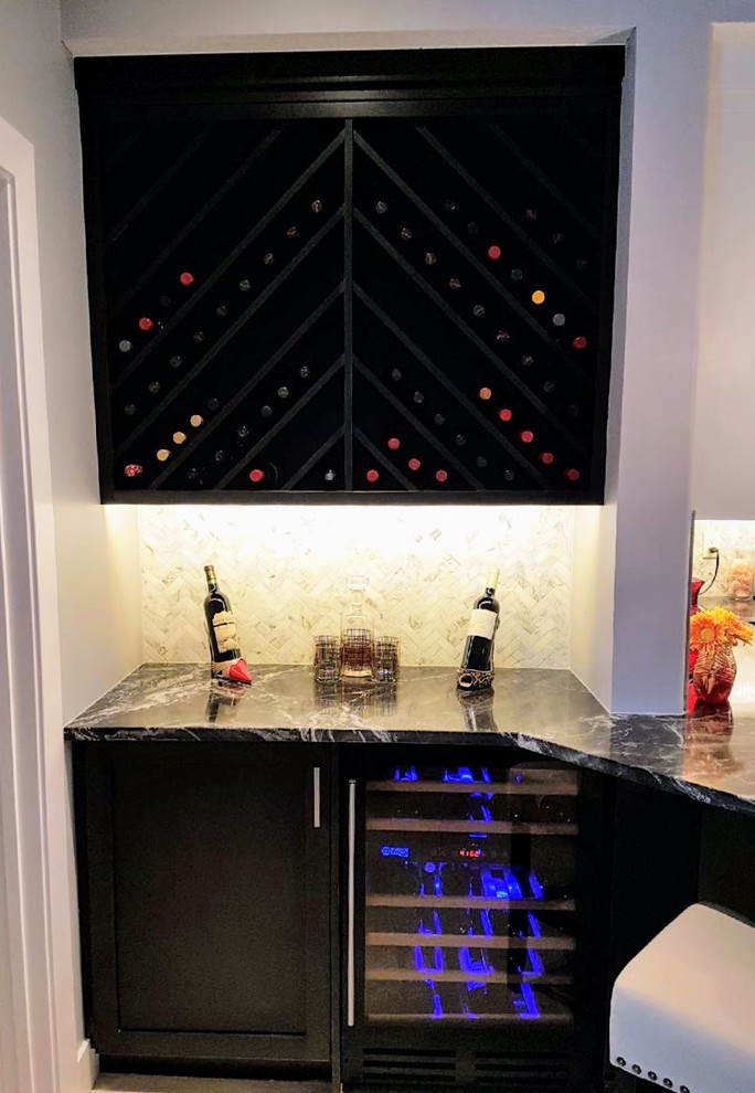 Photo of a small contemporary single-wall wet bar in Calgary with marble splashback, white splashback, no sink, shaker cabinets, dark wood cabinets and marble benchtops.