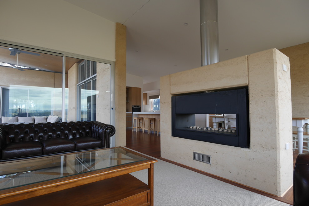 Large contemporary open concept living room in Newcastle - Maitland with dark hardwood floors, a two-sided fireplace and a stone fireplace surround.