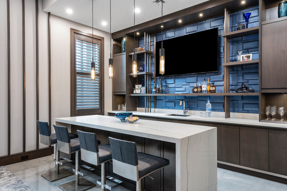 Example of a trendy galley gray floor seated home bar design in Miami with an undermount sink, flat-panel cabinets, dark wood cabinets, marble countertops, blue backsplash and multicolored countertops