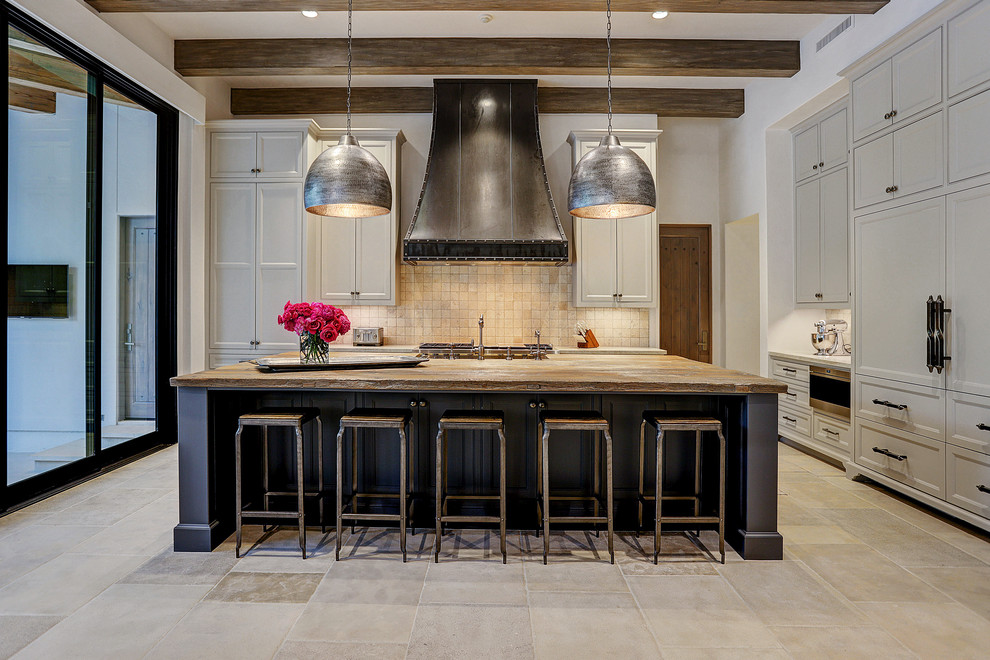 Photo of a transitional l-shaped kitchen in Houston with recessed-panel cabinets, grey cabinets, wood benchtops, beige splashback, mosaic tile splashback, panelled appliances, with island, beige floor and brown benchtop.