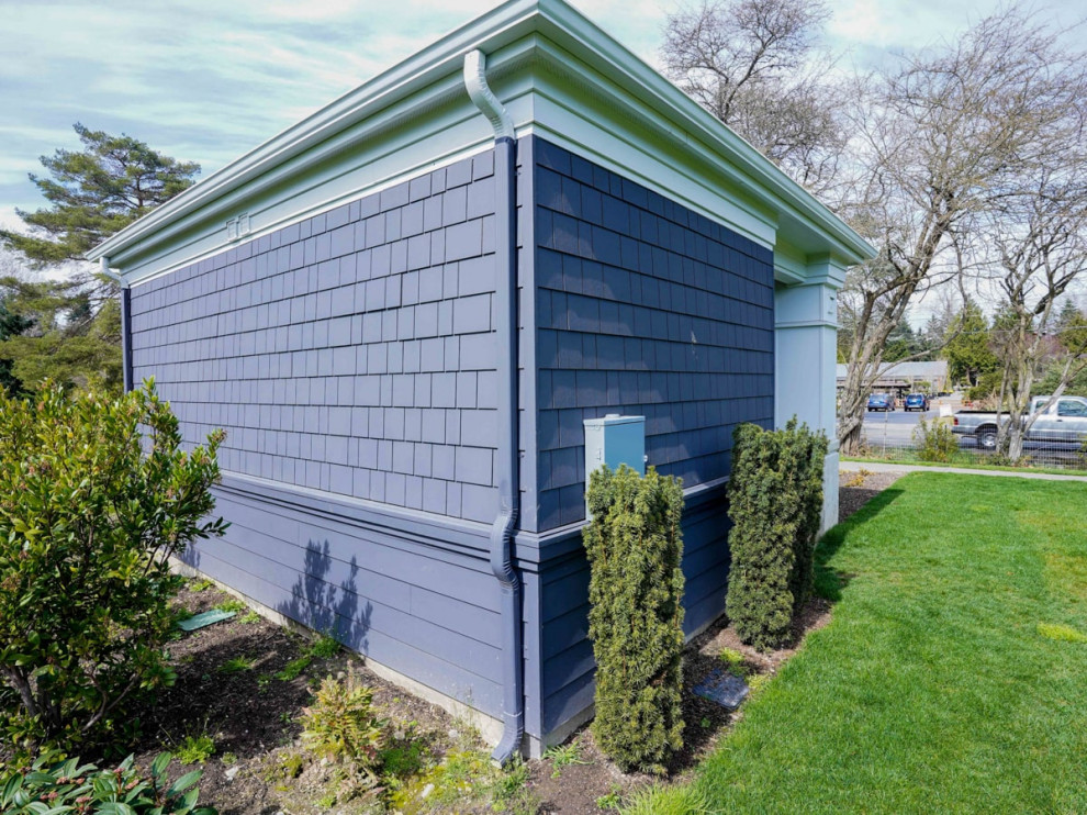 This is an example of a medium sized and gey modern bungalow detached house in Seattle with mixed cladding, a flat roof, a metal roof, a white roof and shingles.