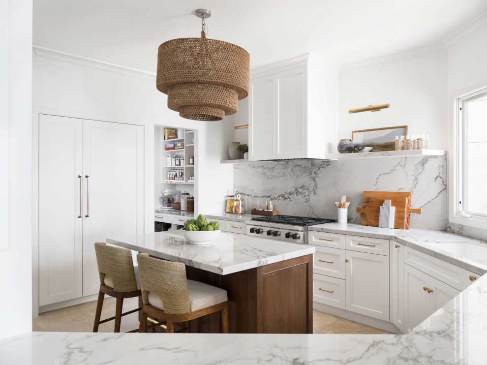 Design ideas for a large transitional u-shaped separate kitchen in San Diego with an undermount sink, white cabinets, quartzite benchtops, grey splashback, stone slab splashback, panelled appliances, limestone floors, with island, beige floor, grey benchtop and recessed-panel cabinets.