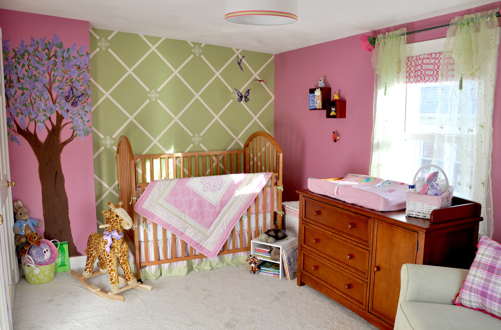 Inspiration for a mid-sized traditional nursery for girls in Boston with multi-coloured walls, carpet and green floor.