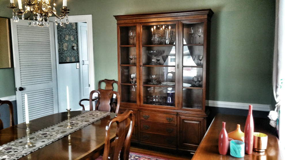 Inspiration for a traditional separate dining room in Providence with green walls, medium hardwood floors and brown floor.