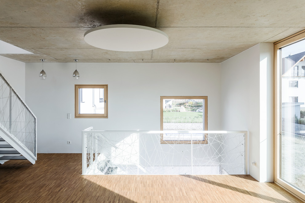 Design ideas for a mid-sized modern loft-style living room in Dresden with light hardwood floors.
