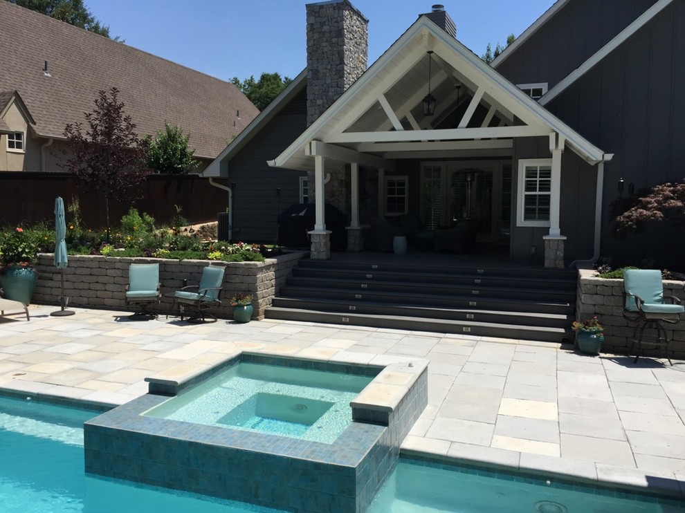 Inspiration for a large transitional backyard concrete paver patio fountain remodel with a roof extension