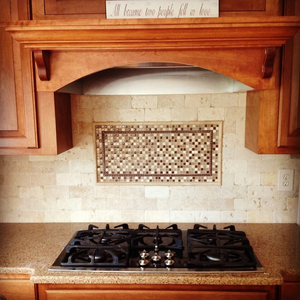 Single-wall kitchen photo with raised-panel cabinets, medium tone wood cabinets, laminate countertops, beige backsplash, ceramic backsplash and stainless steel appliances