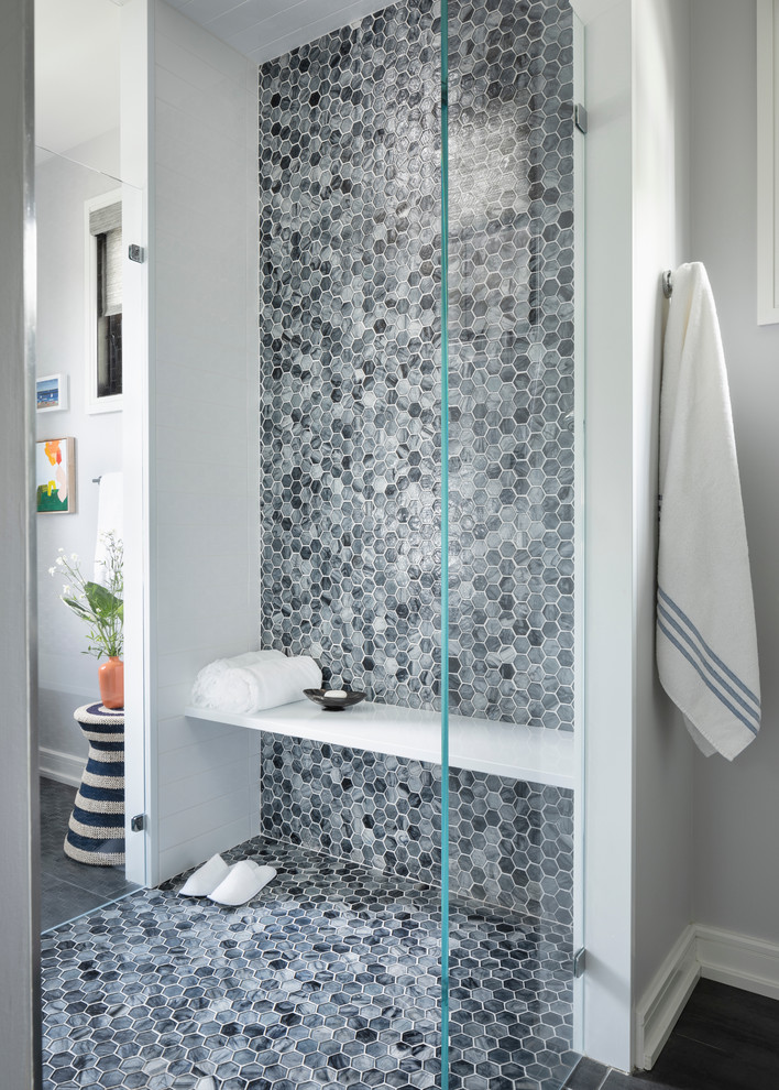 This is an example of a transitional bathroom in New York with a curbless shower, grey walls and a hinged shower door.