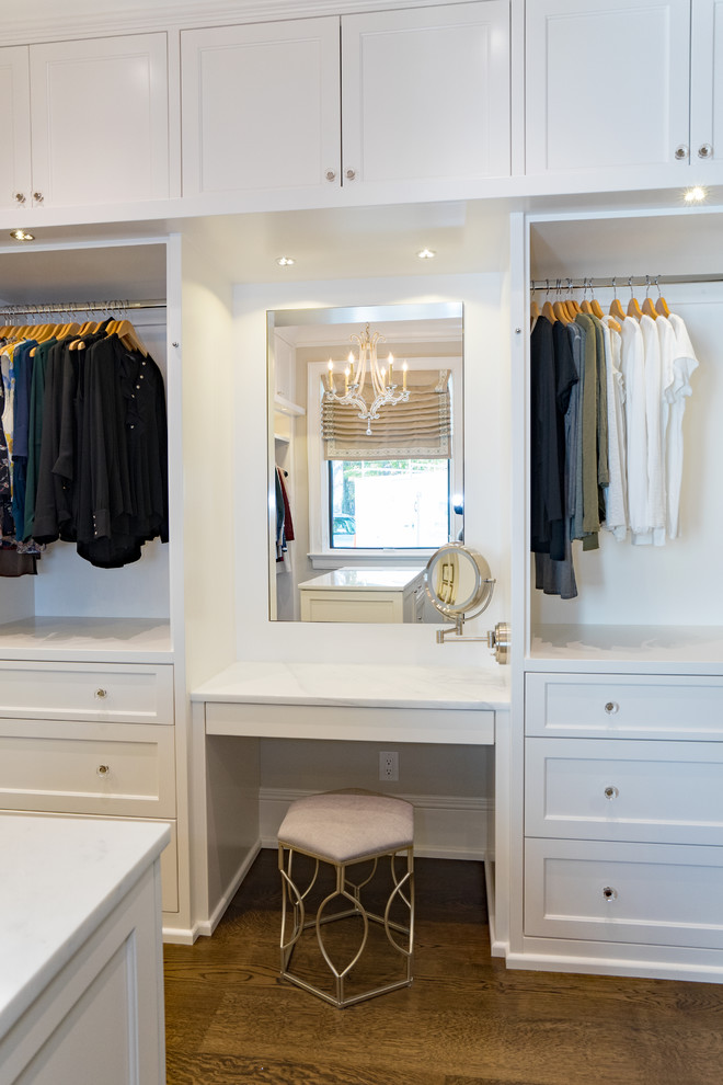 Inspiration for a transitional women's storage and wardrobe in Other with glass-front cabinets and white cabinets.