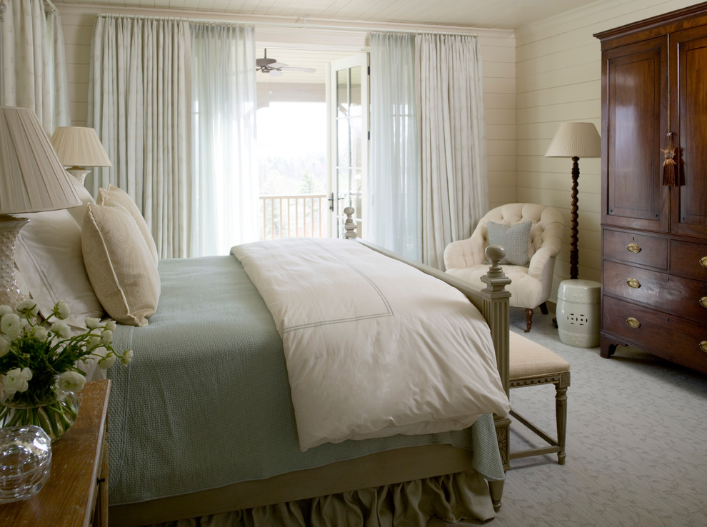 This is an example of a large guest bedroom in Raleigh with white walls and dark hardwood floors.