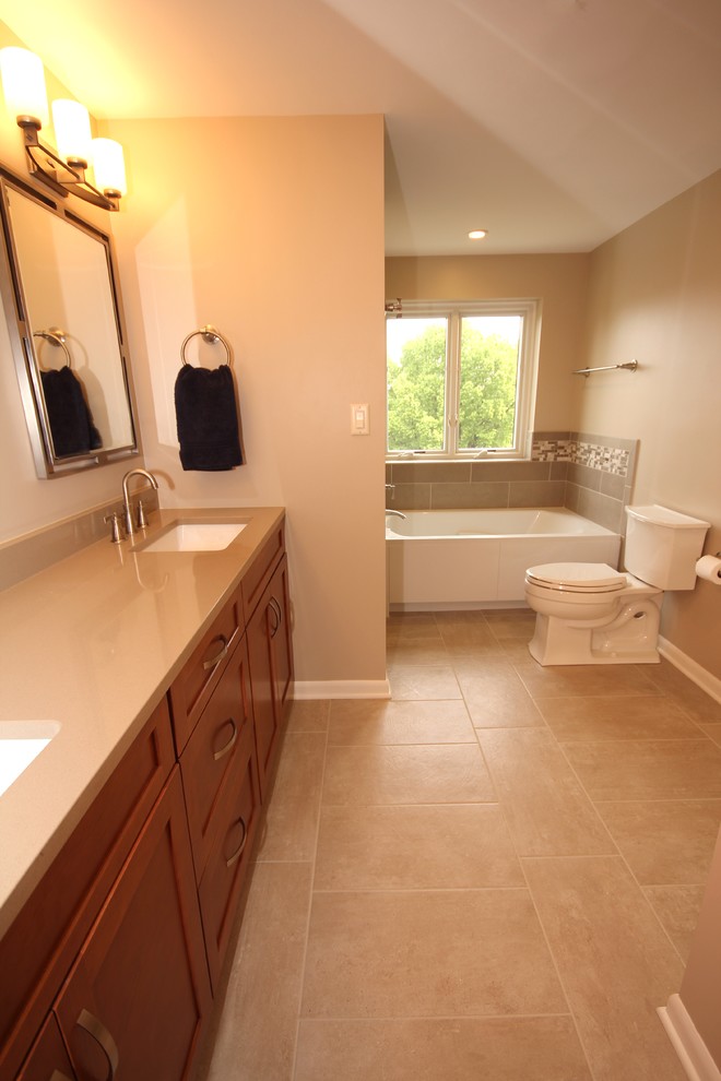 Inspiration for a large transitional master bathroom in Other with medium wood cabinets, ceramic tile, ceramic floors, quartzite benchtops, shaker cabinets, an alcove tub, a corner shower, a one-piece toilet, beige tile, beige walls and an undermount sink.