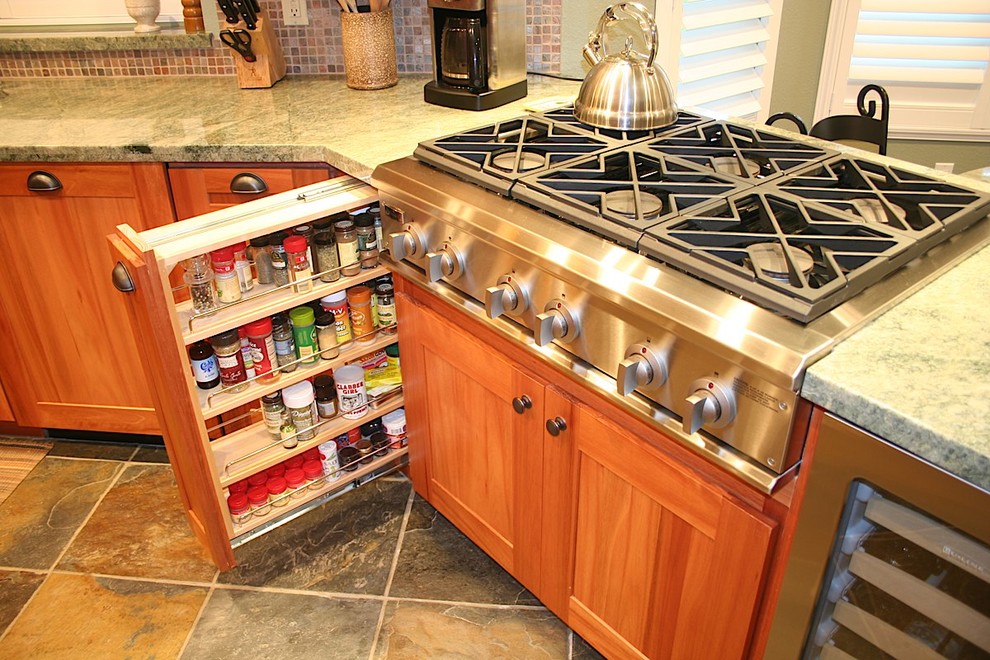 Kitchen - mid-sized transitional u-shaped slate floor kitchen idea with an undermount sink, recessed-panel cabinets, medium tone wood cabinets, granite countertops, green backsplash, stone tile backsplash, stainless steel appliances and no island